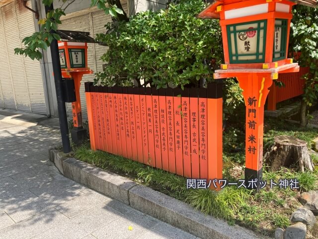 美御前社（八坂神社の末社）の朱塗りの玉垣にある美容関係の専門学校や会社